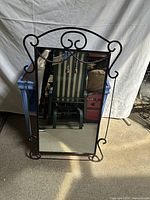 Full view of wrought iron mirror standing upright