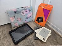 Group shot of all four items: Mosiso laptop sleeve, Amazon Fire HD10 cover box, Griffin Survivor case, Kobo eReader