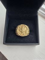 Ring in open box showing crest and weighty band