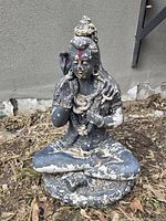 Front view of seated Shiva cement statue