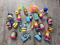 All 21 Minions/Despicable Me figurines spread on wood surface
