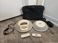 Both JBL speaker docks, dock inserts, cables and pouch overview