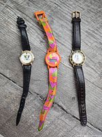 Front view of three wristwatches laid out