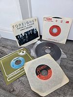 Group shot showing five example 45 rpm records with sleeves