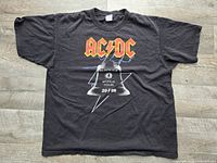 Front view of black AC/DC tour T-shirt laid flat