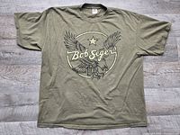 Front view of olive green Bob Seger tour T-shirt laid flat