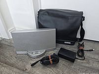 Front view of Bose SoundDock II, power adapter, cable and carrying bag