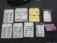 All nine unopened eyelash packages laid out together for full lot view