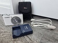 Camera, charger, cable and case grouped