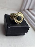 Top view of ring showing black center logo and surrounding text