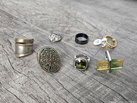 All eight rings laid out on wood surface