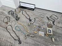 Overview of entire costume jewellery lot spread on floor