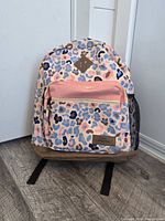 Front view showing camo pattern, front pocket, base