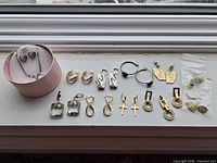 All earrings and necklace laid out on windowsill