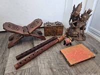 Group shot of all items: statue, flutes, box, book stand, elephant, notebook