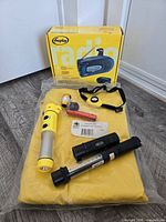 All items overview: radio box, rain jacket, flashlights, headlamp, mini light, whistle