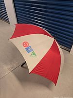 Side view of open red/white umbrella showing CTV logo