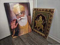 Both wall art pieces standing on floor, full view