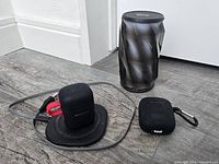 Overall lot showing speaker, both earbud cases, charging pad and cable