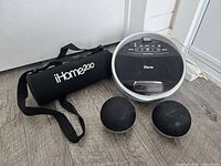 All items grouped: round dock speaker, two ball speakers, carry tube