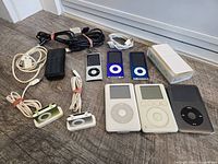 Group shot of all iPods, cables, case and boxed dock
