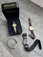 Group view of all four watches and extra strap