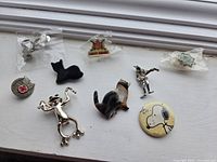 Group shot of all pins and brooches on windowsill