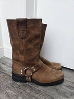 Full side view of both boots showing leather condition, harness strap and heel