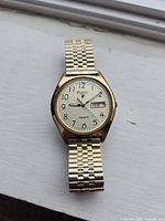 Front view of watch showing dial, case and bracelet