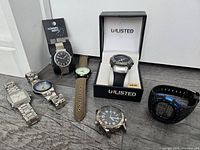 All eight watches arranged on floor for overview