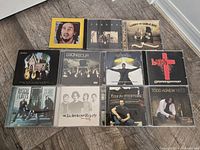 Overview of 12 jewel case CDs on floor