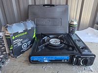 Stove inside open case with Woods butane canisters