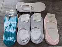 Assorted packaged and loose mid cut socks, various colours