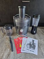 Nutribullet juicer assembled with accessories, Hamilton Beach blender, manuals and brush
