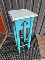 full view of painted wooden plant stand front and side
