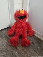 Front view of full Elmo plush