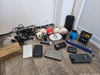 Group shot of all electronics including power banks, speakers, cables, hub