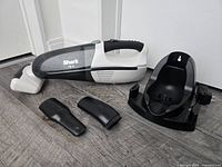 Vacuum with charging cradle, crevice tool, upholstery nozzle