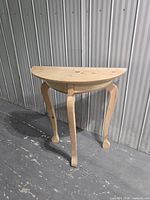 Front angled view of unfinished half-moon table