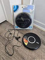Overview of sealed Sony CD Walkman, loose Sony CD Walkman, and earbuds