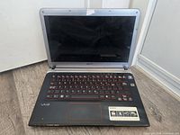 Open Sony VAIO laptop showing screen, keyboard, touchpad