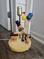 Front view of clown balloon vendor nursery lamp showing figures, balloons and socket