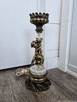 Full view of lamp showing cherub, marble, and pedestal base