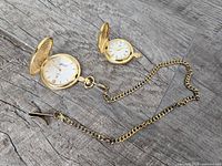 Penman's pocket watch with chain and YR Hunter pocket watch displayed open