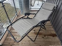 Lounge chair reclined on patio showing overall design, frame, fabric, cushion