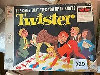 Front of Twister game box showing title, artwork, age recommendation, Milton Bradley logo