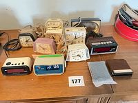 Group shot showing all analog and digital alarm clocks on tabletop