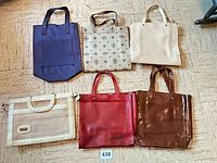 Group shot of all six tote bags laid out