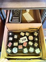 Drawer view showing box of plastic canisters and tray of metal sockets/extenders