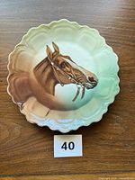 Front view of porcelain plate showing horse design and gradient glaze